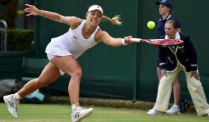 Angelique Kerber of Germany hits a return to Kirsten Flipkens of Belgium in their women's singles tennis match at the Wimbledon Tennis Championships, in London June 28, 2014.            REUTERS/Toby Melville (BRITAIN  - Tags: SPORT TENNIS)